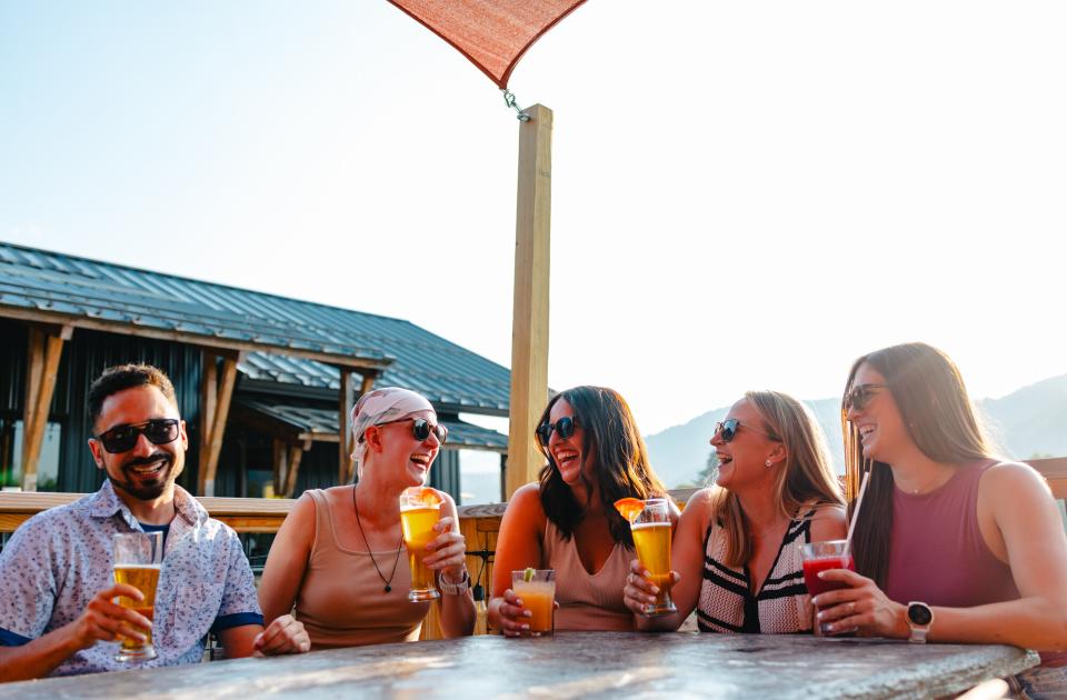 a group of people cheersing at Paradox Brewery